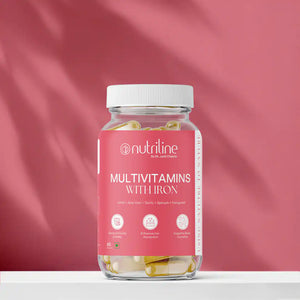 A jar of Multivitamins With Iron capsules rests on a white surface with a pink background. The label highlights benefits such as immunity support, improved iron absorption, and healthy blood production.
