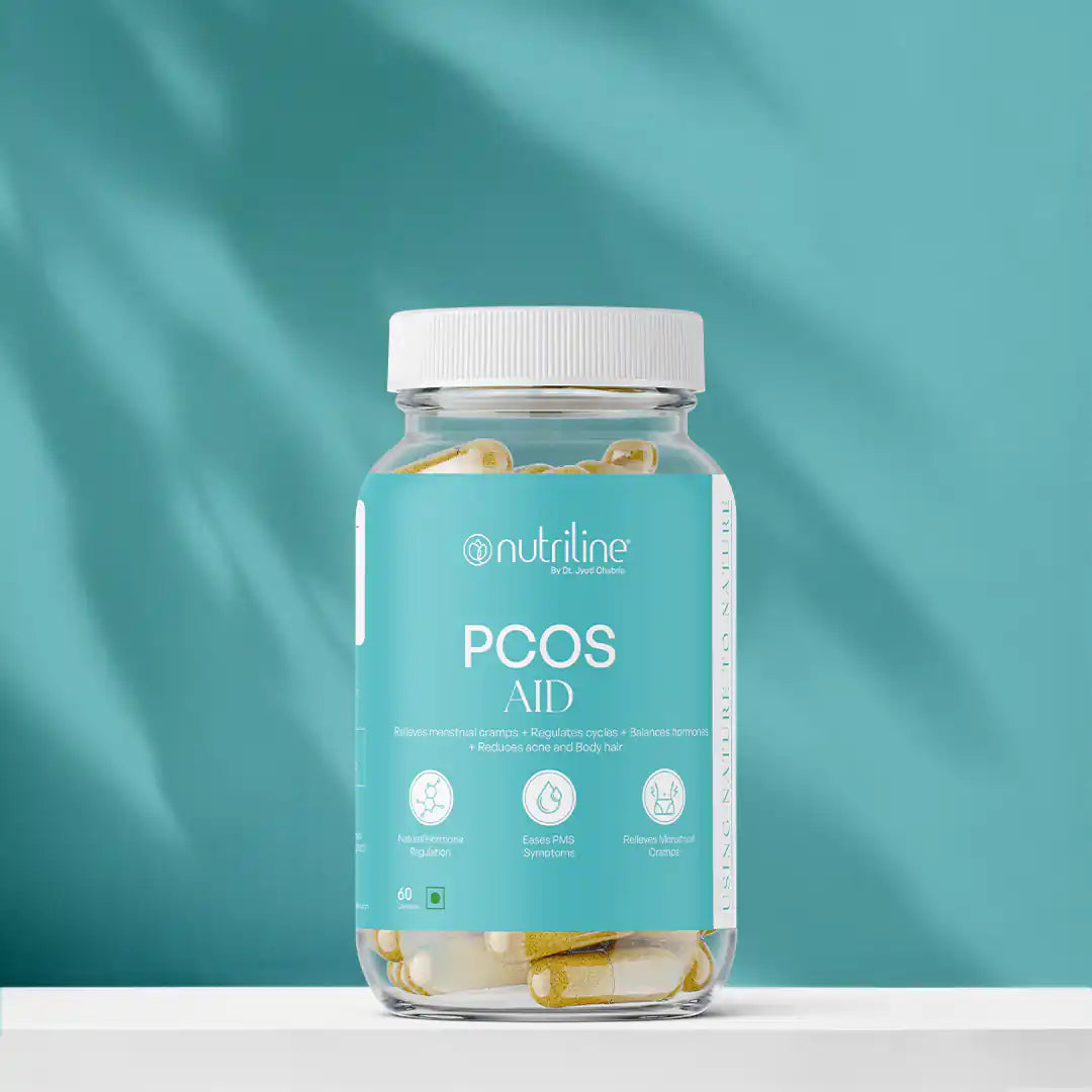 A clear bottle labeled PCOS Aid with yellow and white capsules sits against a blue background. The label highlights support for PCOS, hormone balance, PMS relief, and menstrual cycle regulation.