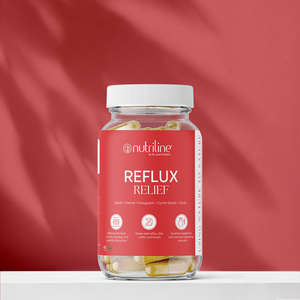 A clear jar labeled Reflux Relief, containing capsules, is set against a pink background. The label promotes natural ingredients and benefits like reducing acid reflux and soothing heartburn for digestive comfort.